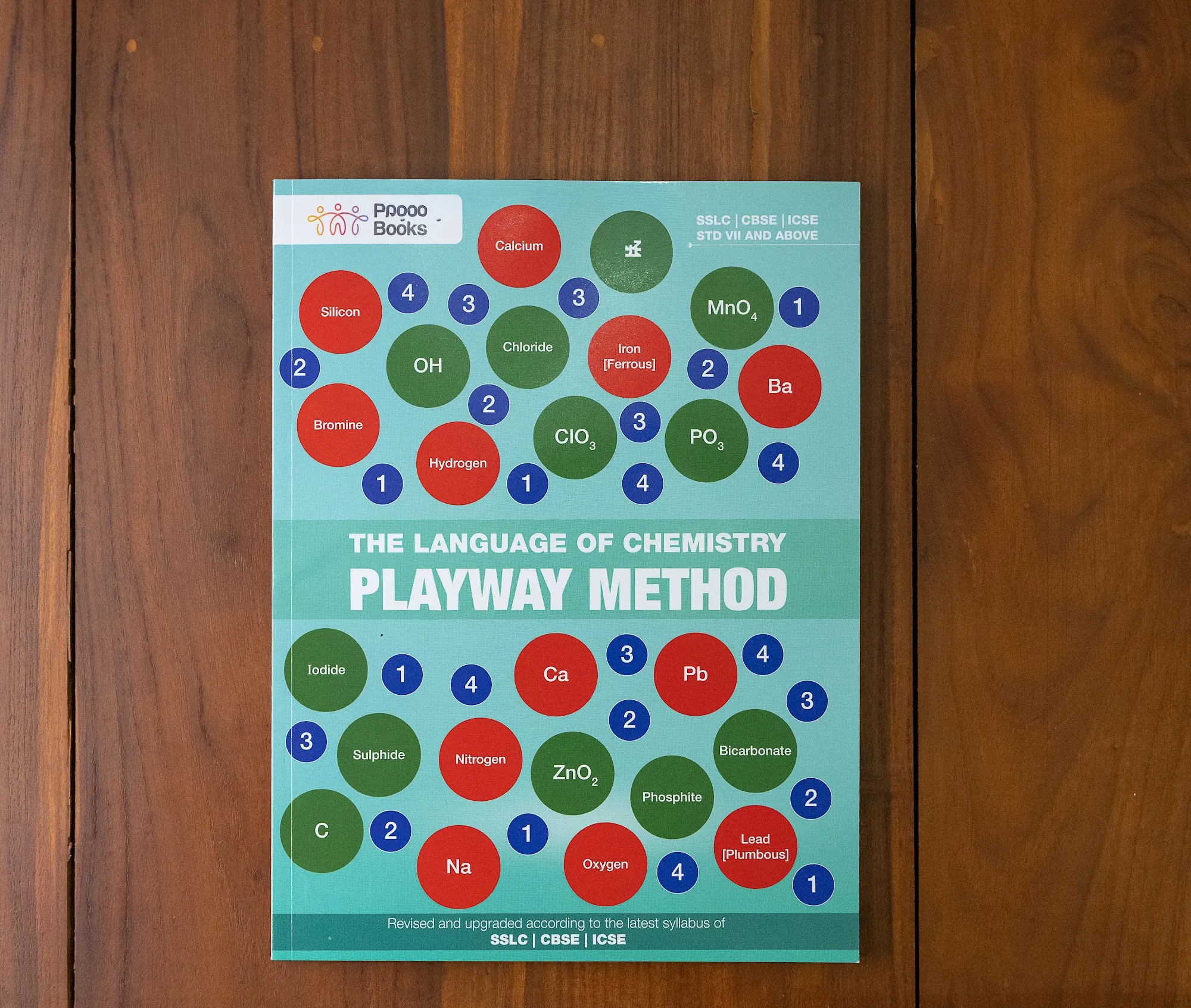 The Language of Chemistry cover, laid flat on a wood table.