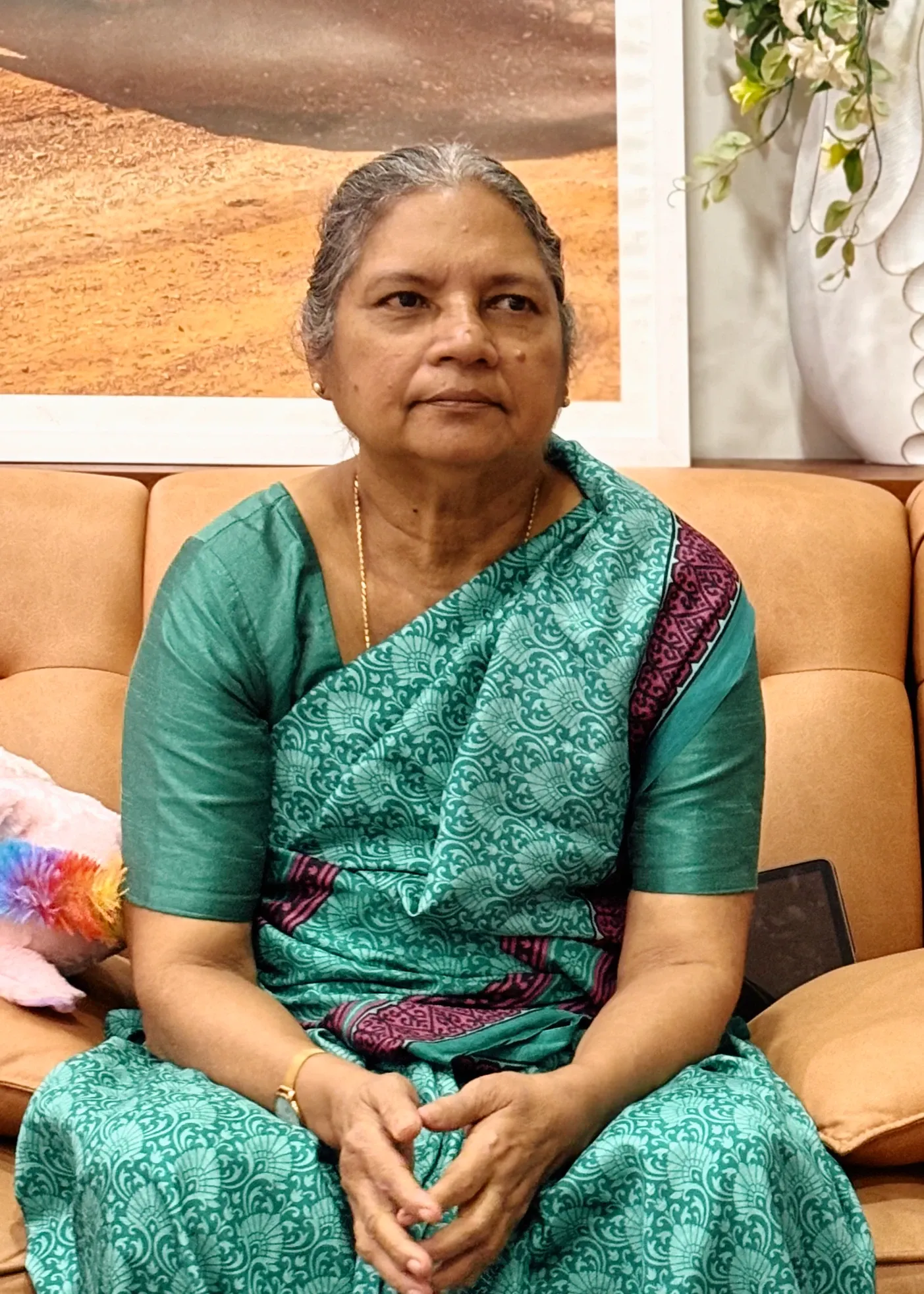 Lilly Joseph, the author of The Language of Chemistry, Playbook®, seated and facing the camera.